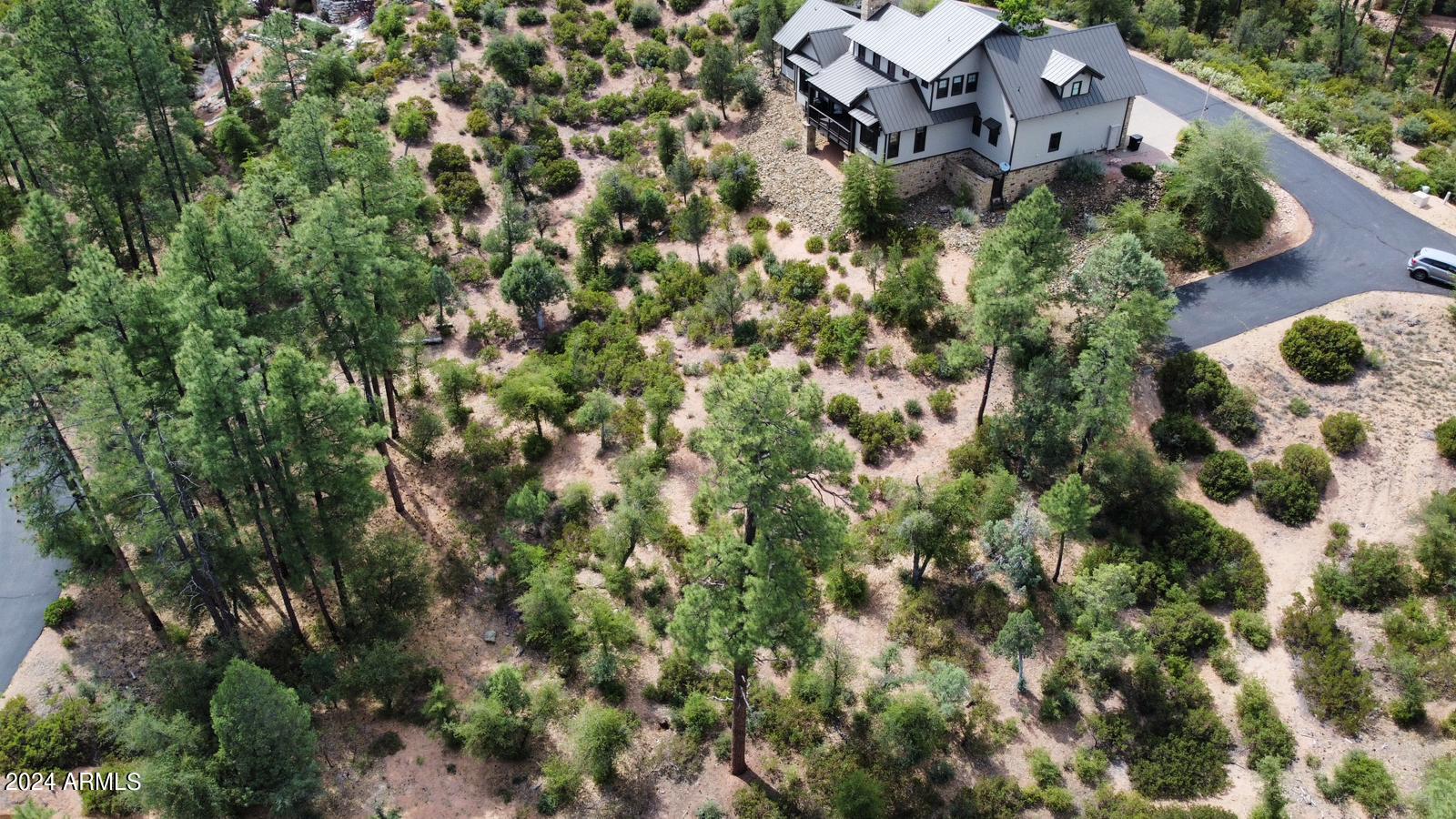 3009 East Arrow Point, Unit 241 Payson, AZ 85541 - Photo 4 of 13 an aerial view of a house with a yard and parking spaces