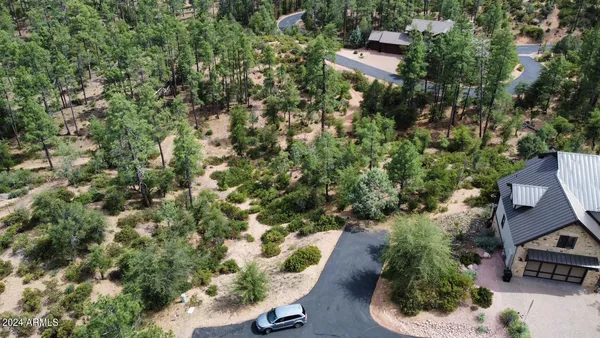 an aerial view of a house with a yard and trees