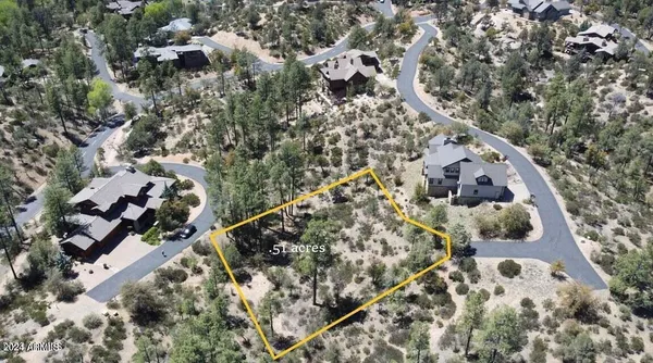 an aerial view of a house with a yard and wooden fence
