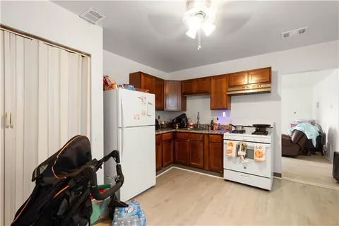 a kitchen with a refrigerator and a stove top oven