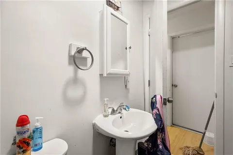 a bathroom with a sink mirror and toilet