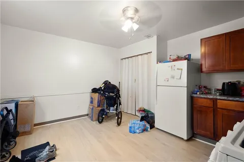a view of a kitchen with fridge and workspace