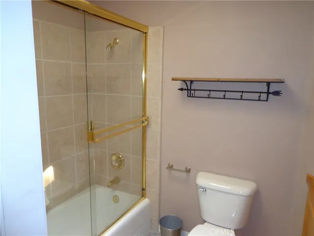 a bathroom with a shower and a toilet