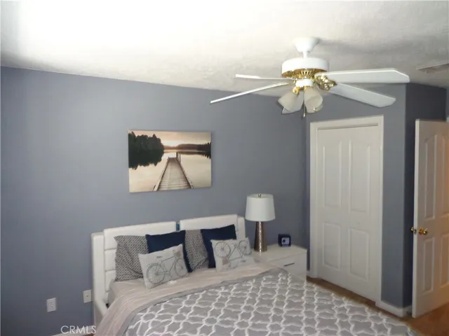 a bedroom with a bed and a painting on the wall