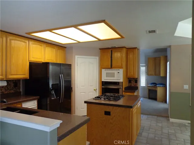 a kitchen with a refrigerator and a sink