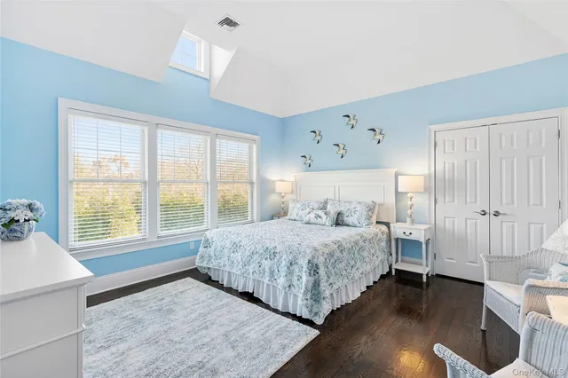 a bedroom with a large bed and a window