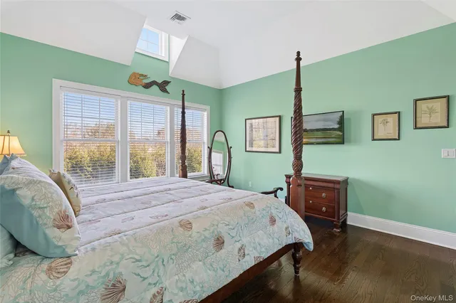 a bedroom with a bed dresser and a window