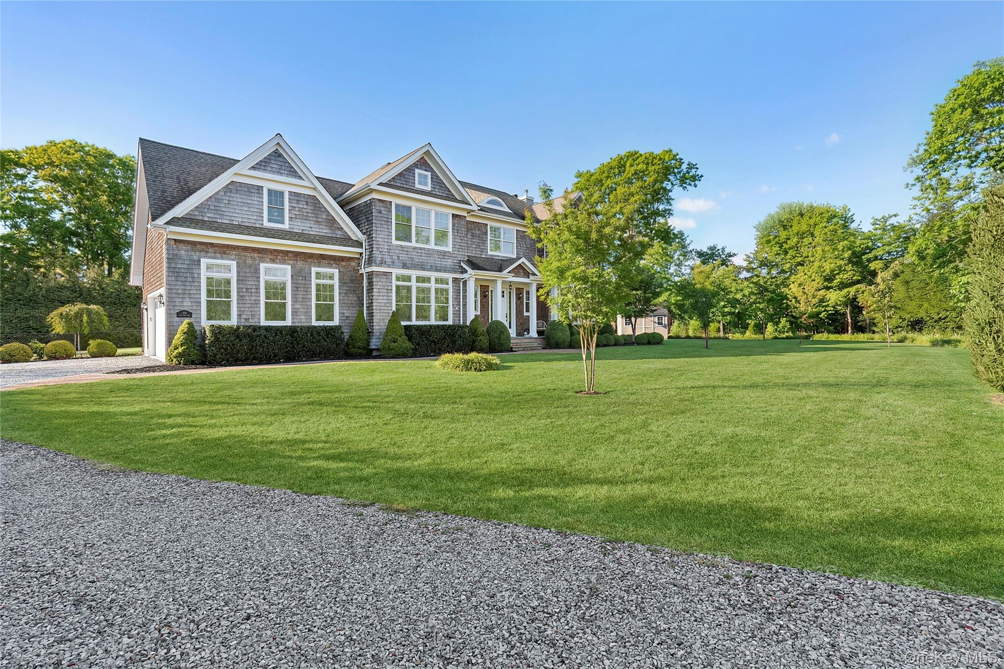 106 East Tiana Road Hampton Bays, NY 11946 - Photo 2 of 28 a front view of a house with a yard