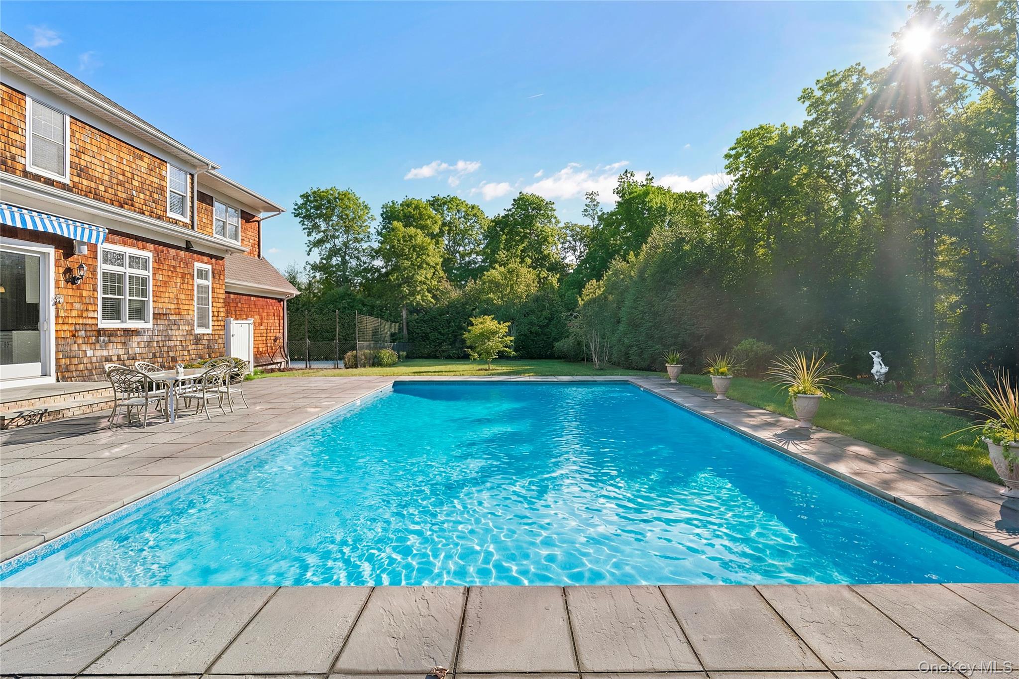 106 East Tiana Road Hampton Bays, NY 11946 - Photo 27 of 28 a view of swimming pool with outdoor seating and plants