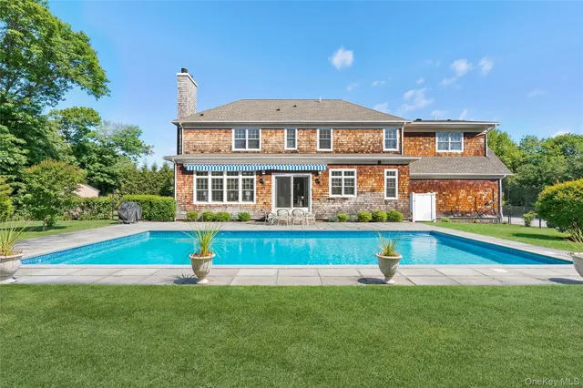 a front view of a house with a yard table and chairs
