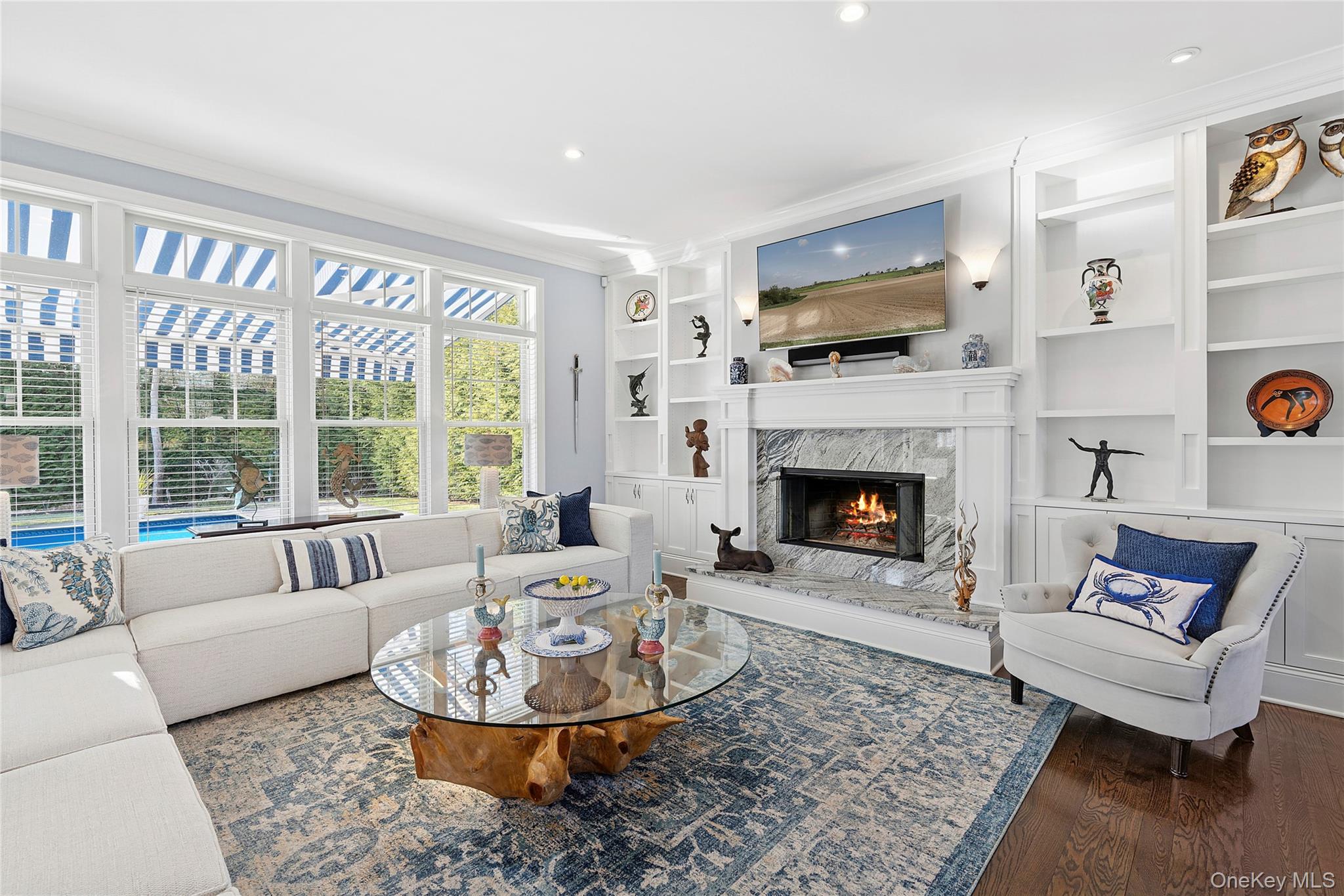 106 East Tiana Road Hampton Bays, NY 11946 - Photo 5 of 28 a living room with furniture a large window and a fireplace