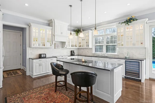 a kitchen with a stove a sink and cabinets