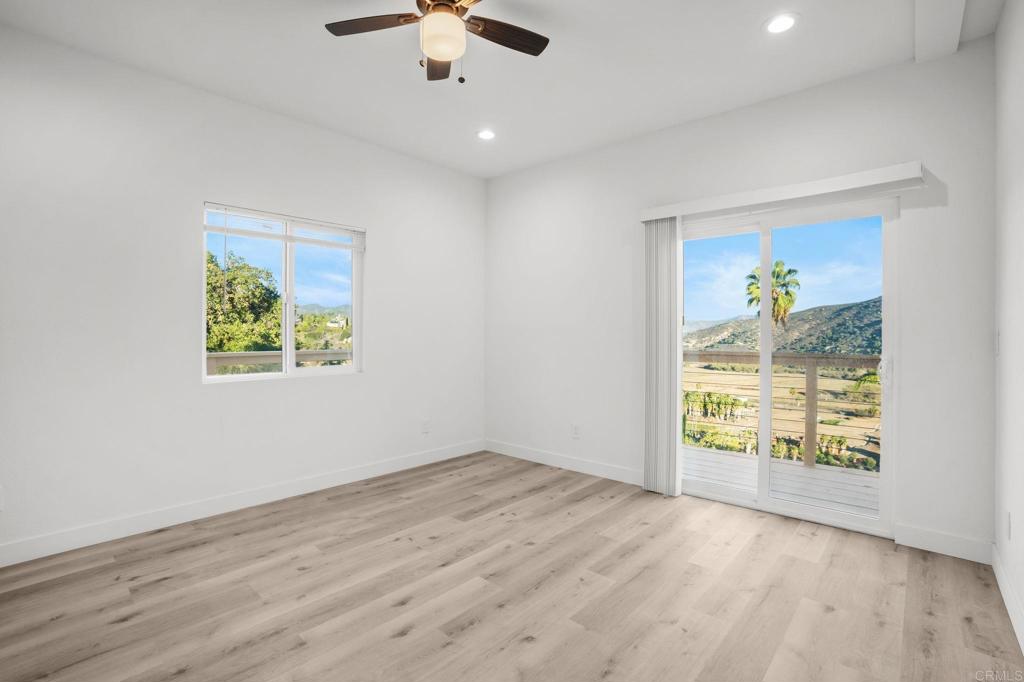 2918 Anaheim Street Escondido, CA 92025 - Photo 3 of 10 an empty room with windows and chandelier fan