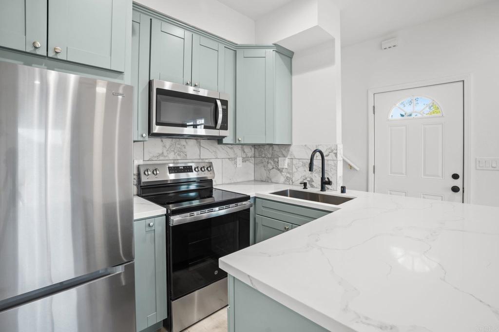 2918 Anaheim Street Escondido, CA 92025 - Photo 4 of 10 a kitchen with stainless steel appliances a refrigerator stove and microwave