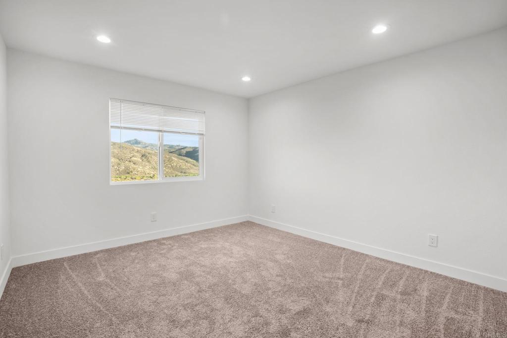 2918 Anaheim Street Escondido, CA 92025 - Photo 7 of 10 an empty room with wooden floor and window