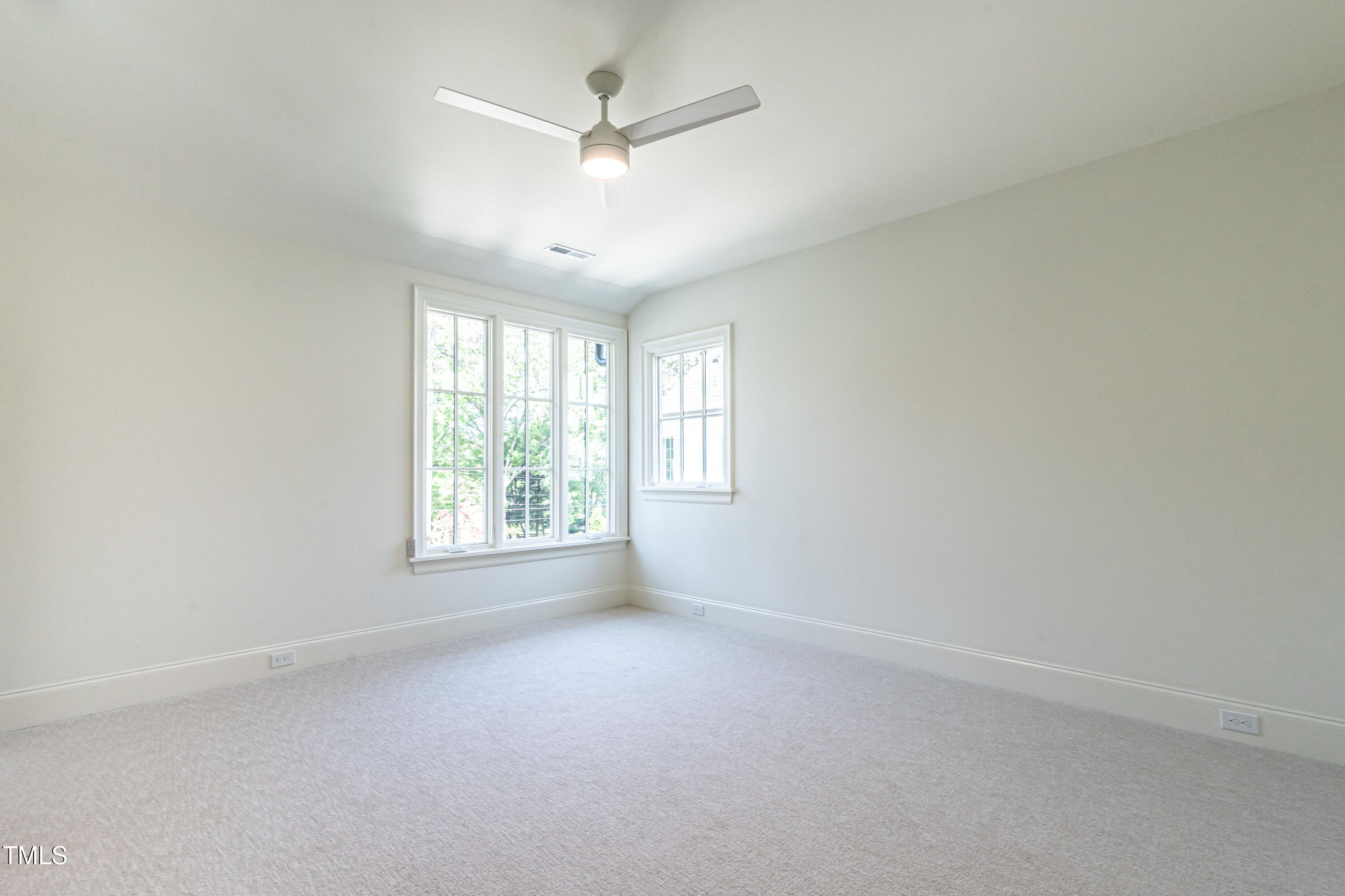 1222 Duplin Road Raleigh, NC 27607 - Photo 23 of 39 an empty room with a window and a fan