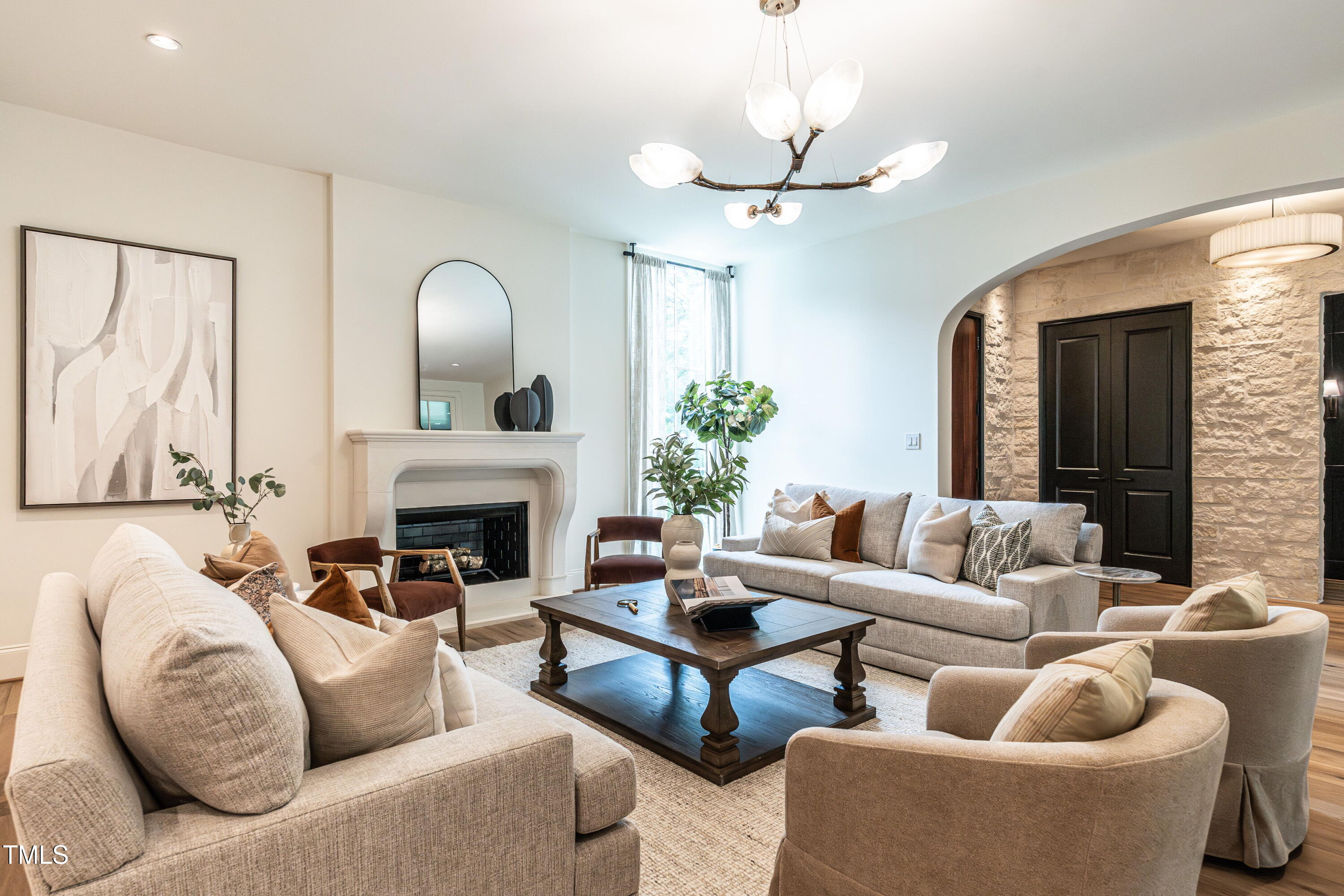 1222 Duplin Road Raleigh, NC 27607 - Photo 5 of 39 a living room with furniture a fireplace and a chandelier