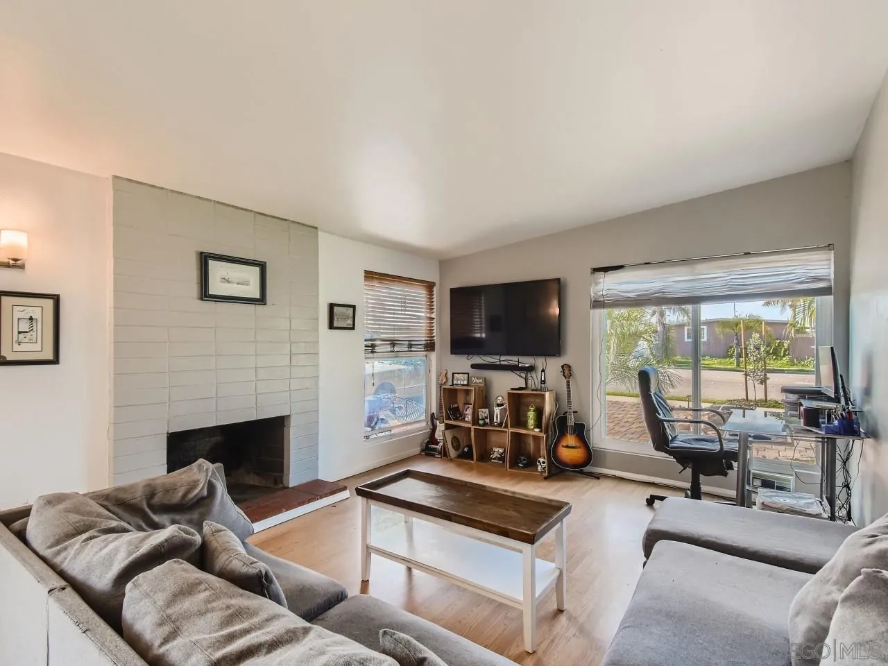 1401 9th Street Imperial Beach, CA 91932 - Photo 12 of 26 a living room with furniture a flat screen tv and a large window
