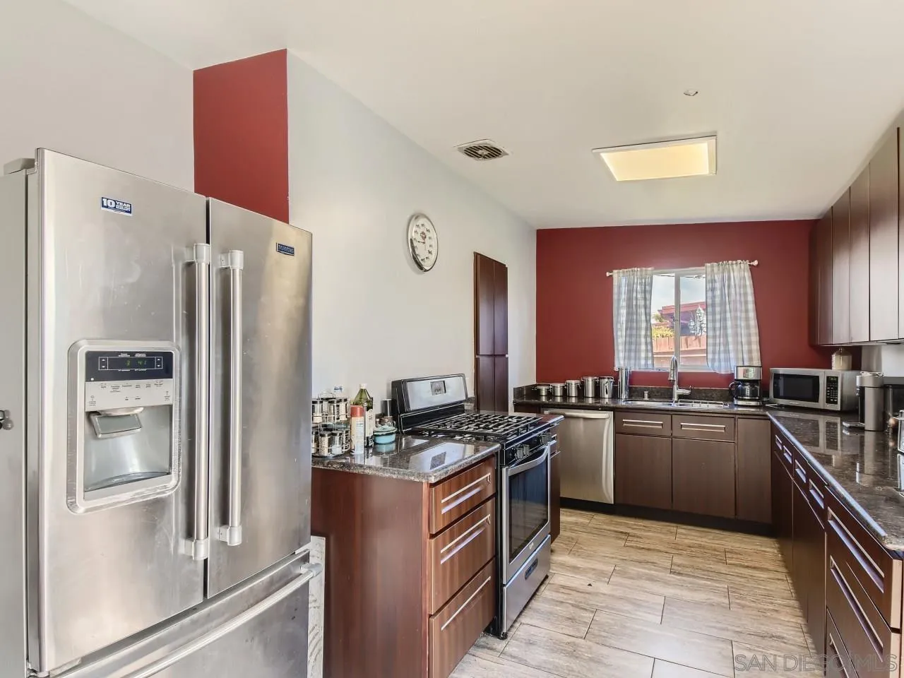 1401 9th Street Imperial Beach, CA 91932 - Photo 7 of 26 a kitchen with stainless steel appliances granite countertop a refrigerator stove and sink