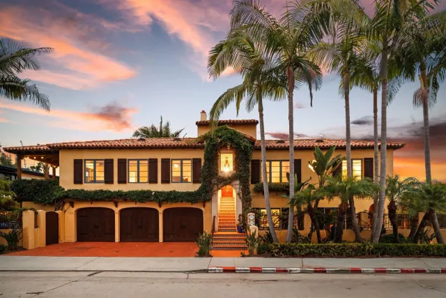 a front view of multiple houses with a yard