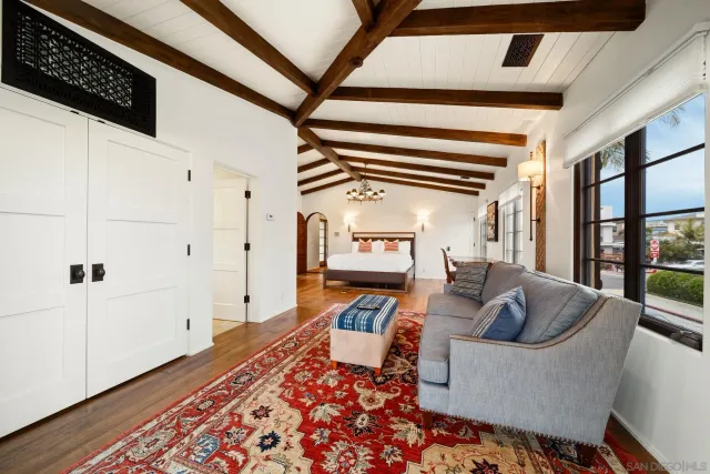 a dining room with furniture a chandelier and wooden floor