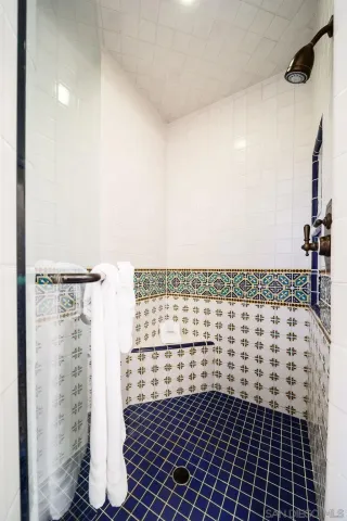 a bathroom with a sink a mirror and a shower