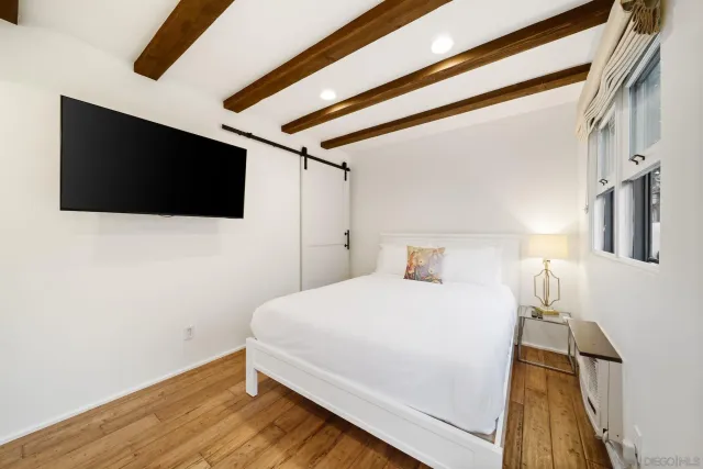 front view of a building with a palm tree