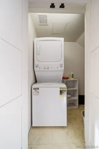 a backyard of a house with barbeque oven table and chairs