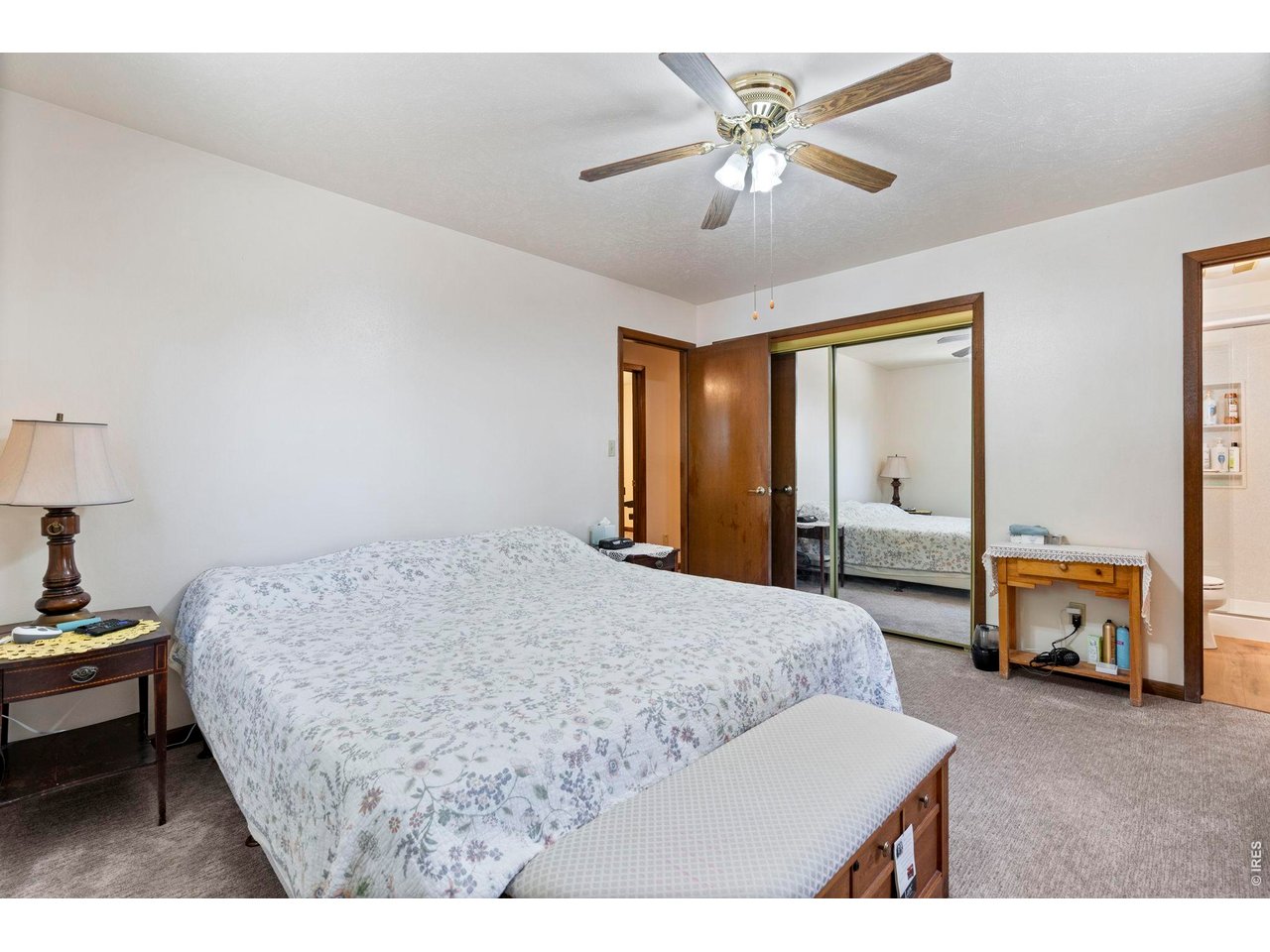 300 Ranch Acres Drive Loveland, CO 80538 - Photo 16 of 38 a bedroom with a bed and a chandelier