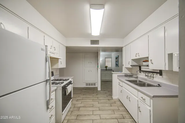 a kitchen with stainless steel appliances a refrigerator stove and sink