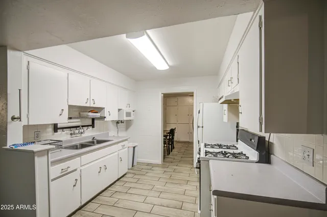 a kitchen with a sink stove and refrigerator