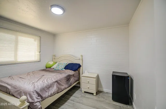 a bedroom with a bed and a window