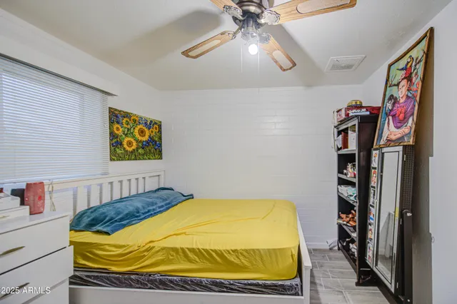 a bedroom with a bed and a book shelf
