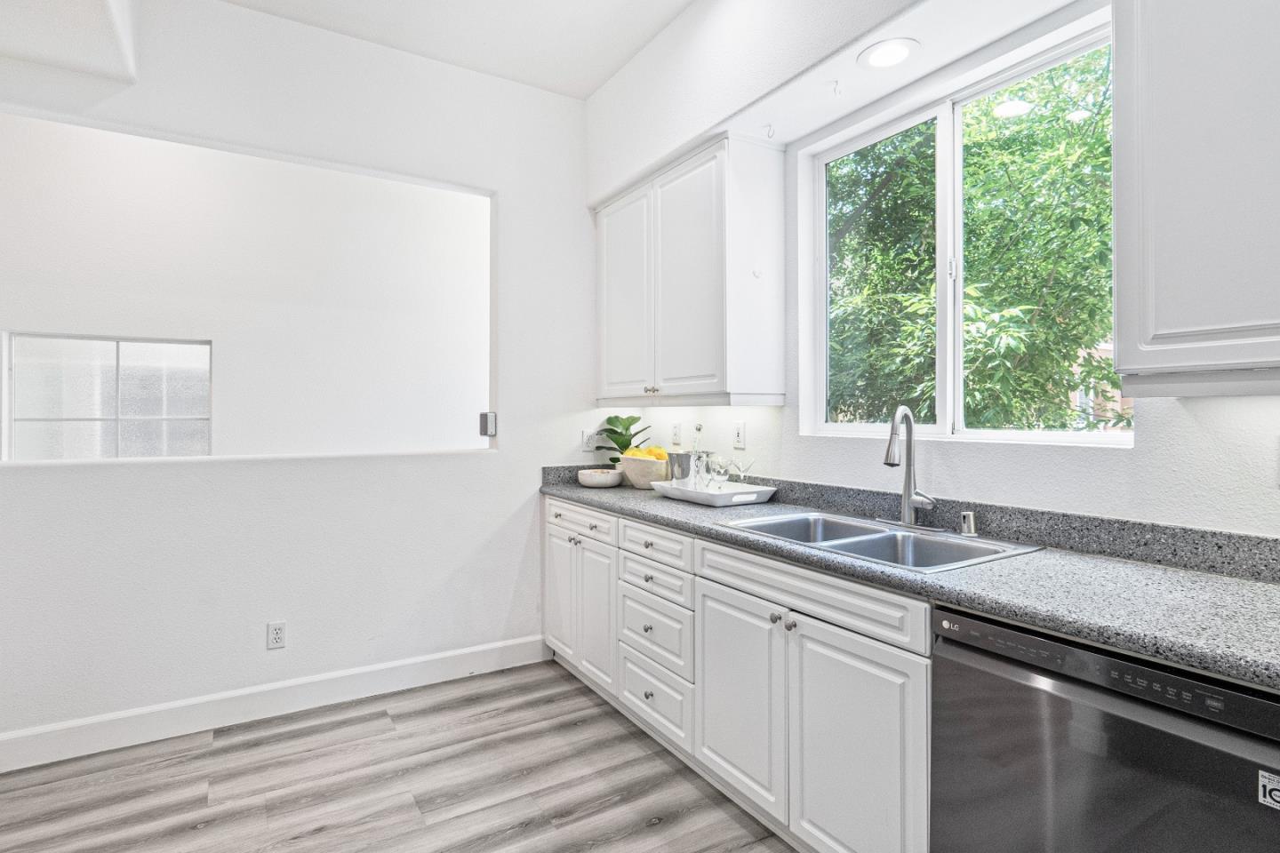 827 Harmony Place Milpitas, CA 95035 - Photo 11 of 36 a kitchen with granite countertop stainless steel appliances a sink window and cabinets