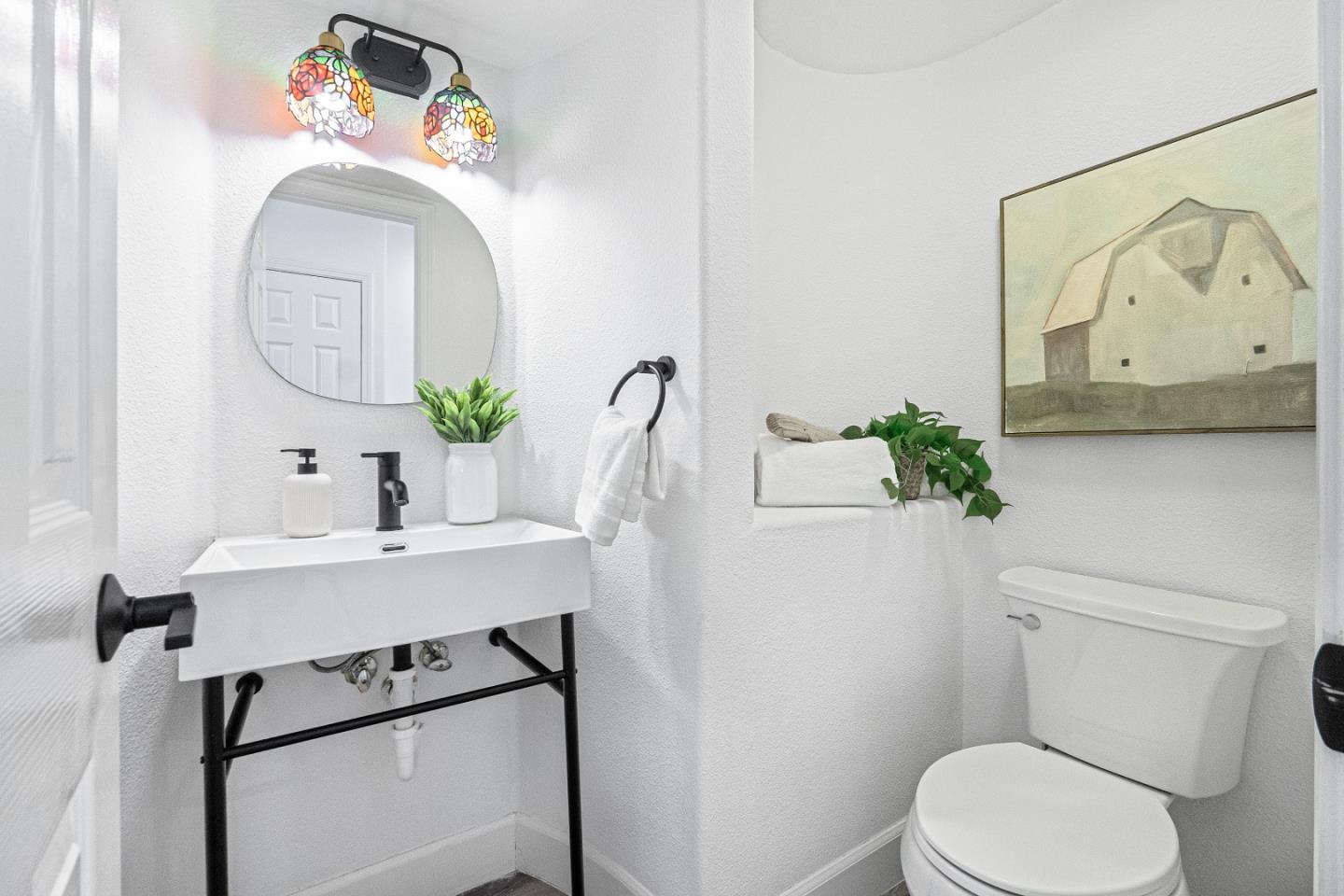 827 Harmony Place Milpitas, CA 95035 - Photo 12 of 36 a bathroom with a toilet sink and mirror