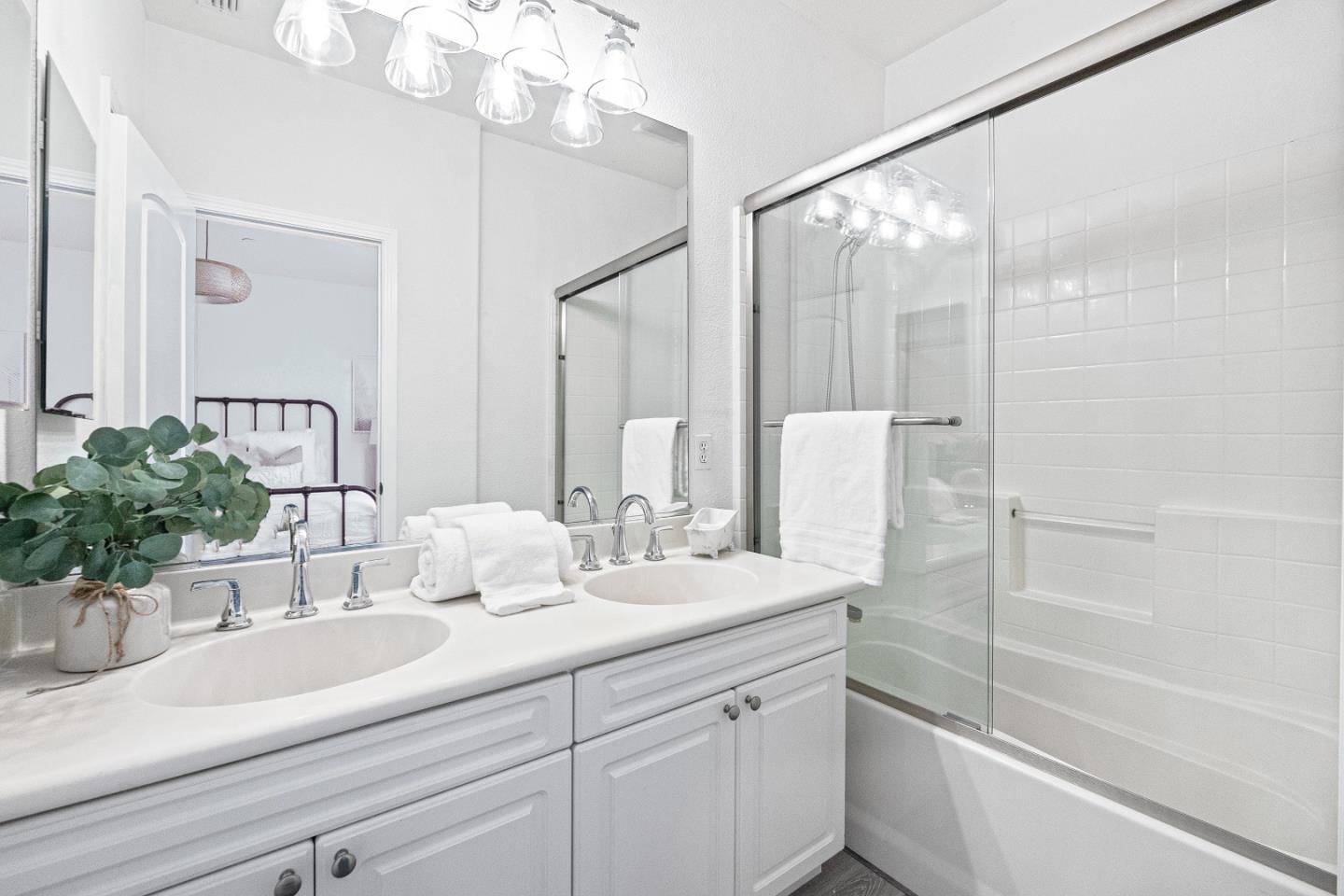 827 Harmony Place Milpitas, CA 95035 - Photo 15 of 36 a bathroom with a sink a large mirror and shower