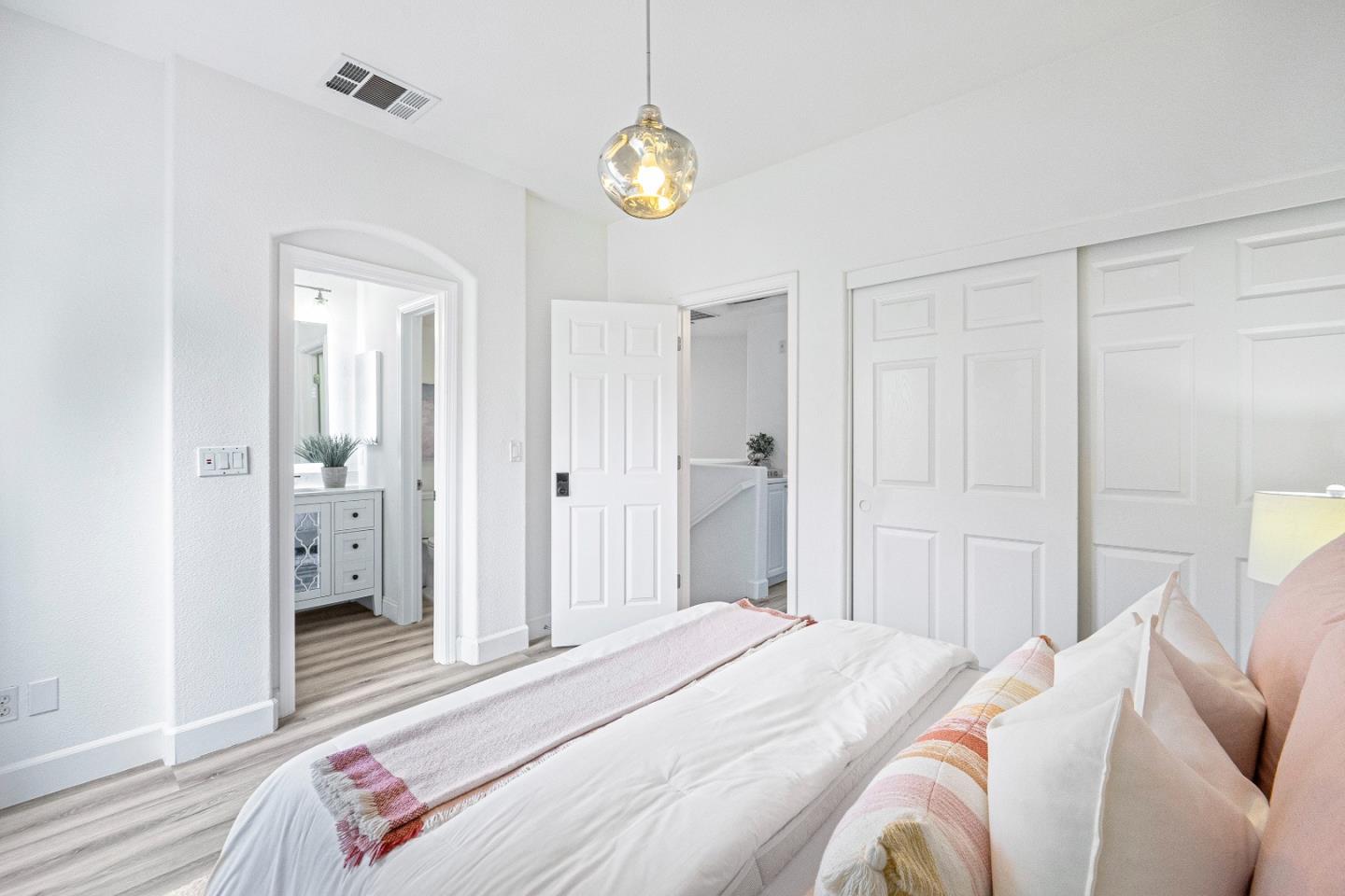 827 Harmony Place Milpitas, CA 95035 - Photo 17 of 36 a bedroom with a bed and a chandelier