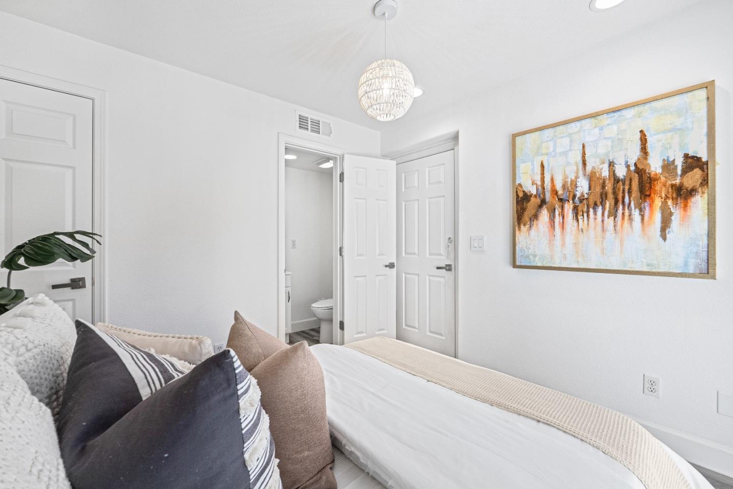 827 Harmony Place Milpitas, CA 95035 - Photo 23 of 36 a bedroom with a bed and a chandelier