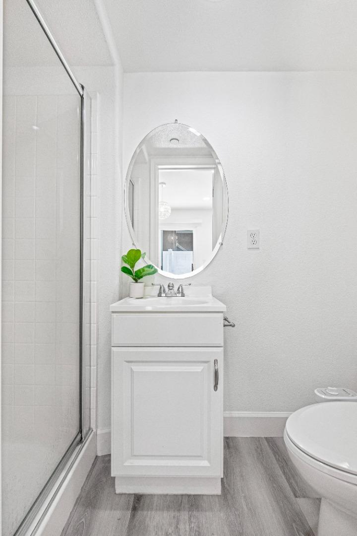 827 Harmony Place Milpitas, CA 95035 - Photo 24 of 36 a bathroom with a toilet a sink and mirror