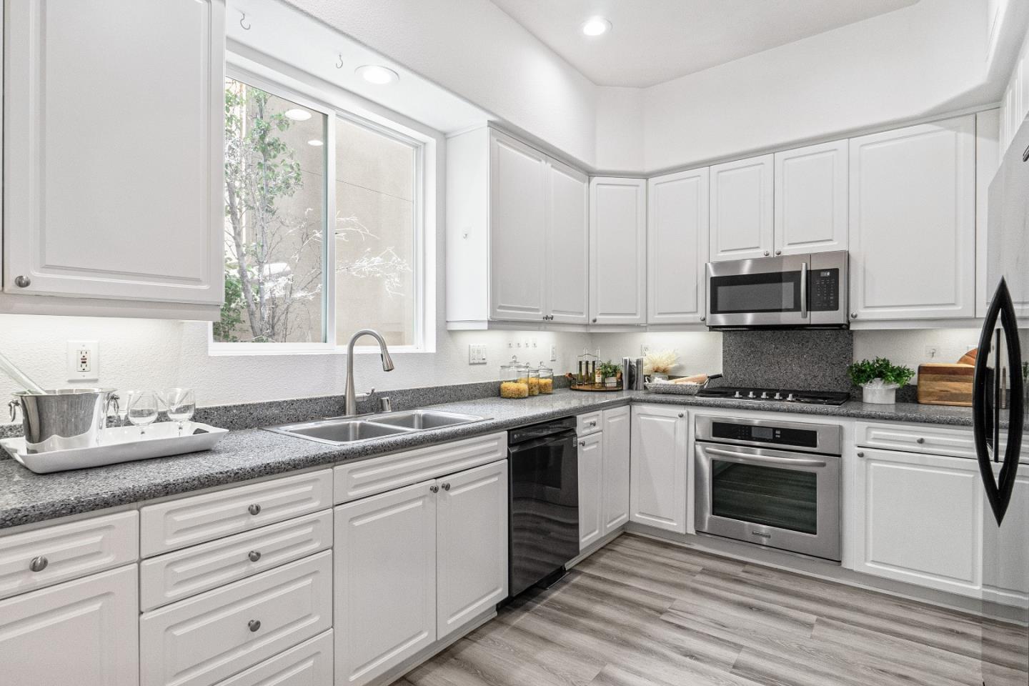 827 Harmony Place Milpitas, CA 95035 - Photo 8 of 36 a kitchen with granite countertop white cabinets and appliances