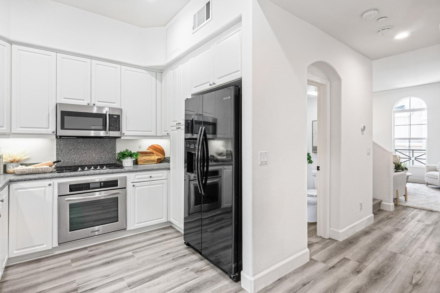 827 Harmony Place Milpitas, CA 95035 - Photo 10 of 36 a kitchen with stainless steel appliances granite countertop a stove and a refrigerator