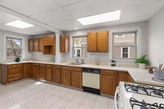 a large kitchen with a sink and cabinets