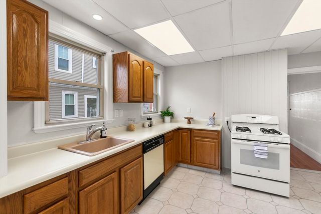 a kitchen with a sink stove and cabinets