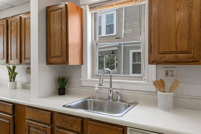 a kitchen with stainless steel appliances granite countertop a sink and a wooden cabinets