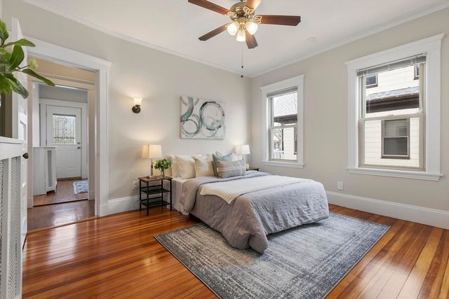 a bedroom with a large bed and a window