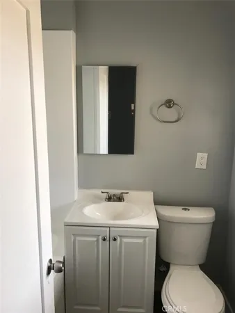 a bathroom with a sink toilet and a mirror
