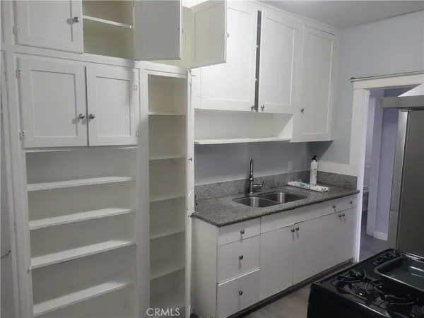 a kitchen with white cabinets and a sink