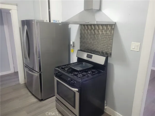 a kitchen with stainless steel appliances and a refrigerator