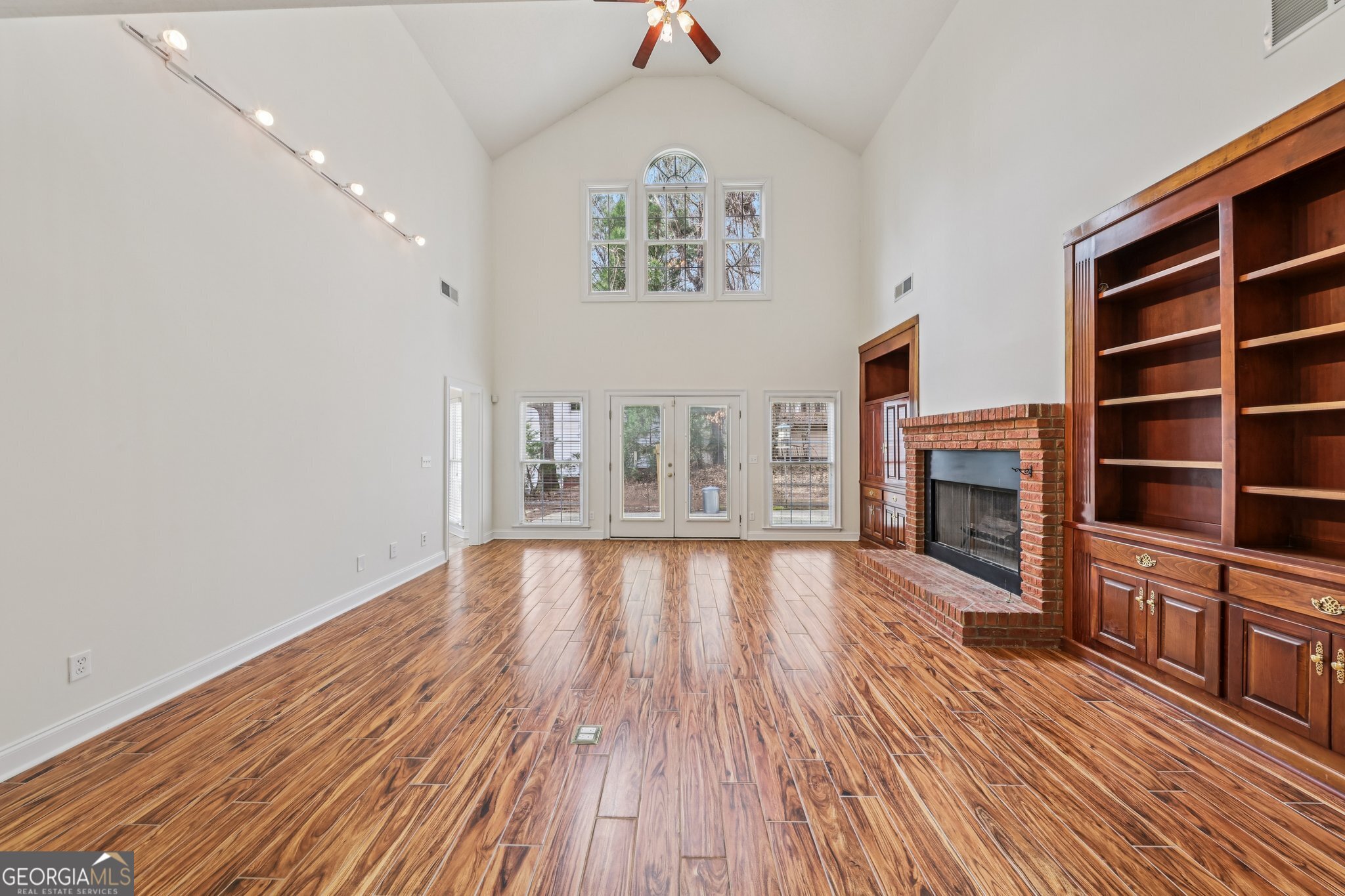 378 Pierce Chapel Road Newnan, GA 30263 - Photo 13 of 66 wooden floor in an empty room with a fireplace