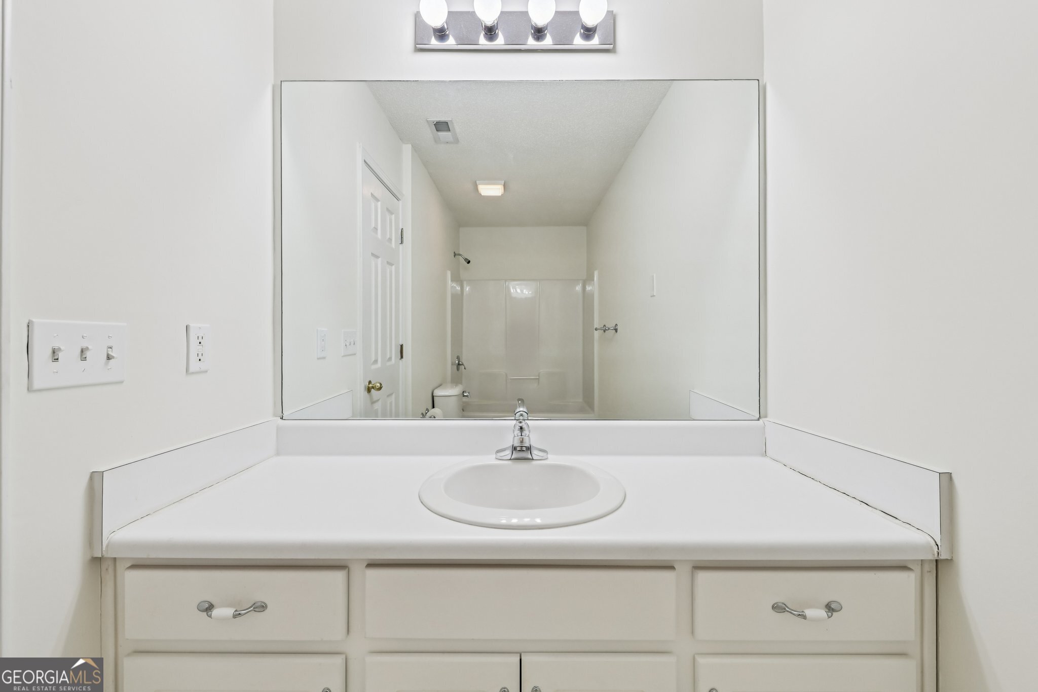 378 Pierce Chapel Road Newnan, GA 30263 - Photo 33 of 66 a bathroom with a sink and a mirror